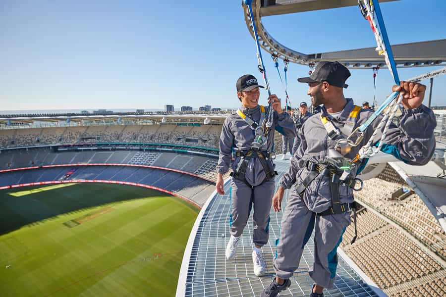 Perth: Optus Stadium Rooftop Vertigo Experience - Leaning over the edge with a harness